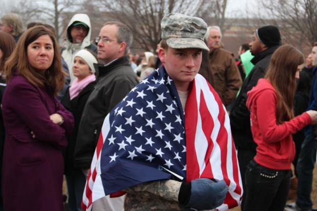 Solider in flag during the Westboro Baptist Church Protest.