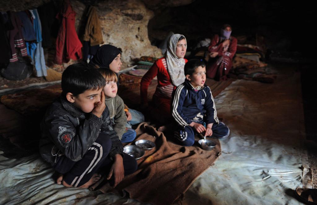 Fleeing bombardment of their village by Syria's Assad regime, "Um Ali," 38, as the mother of six children asked to be called, sits in the back of the cave they have found as their own shelter. The cave, just outside the village of al Sahriah, measures about 12 by 35 feet. (Andree Kaiser/MCT)