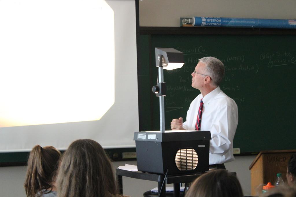 Harned teaching one of his classes with an overhead projector (Olivia MacDougal).