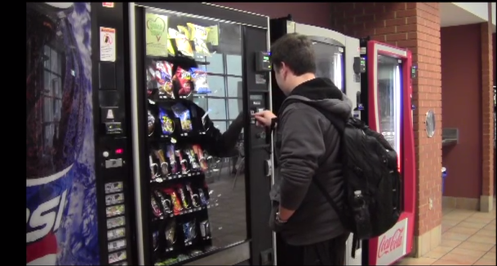 A CHS student selects a lunch item from the school vending machine. 