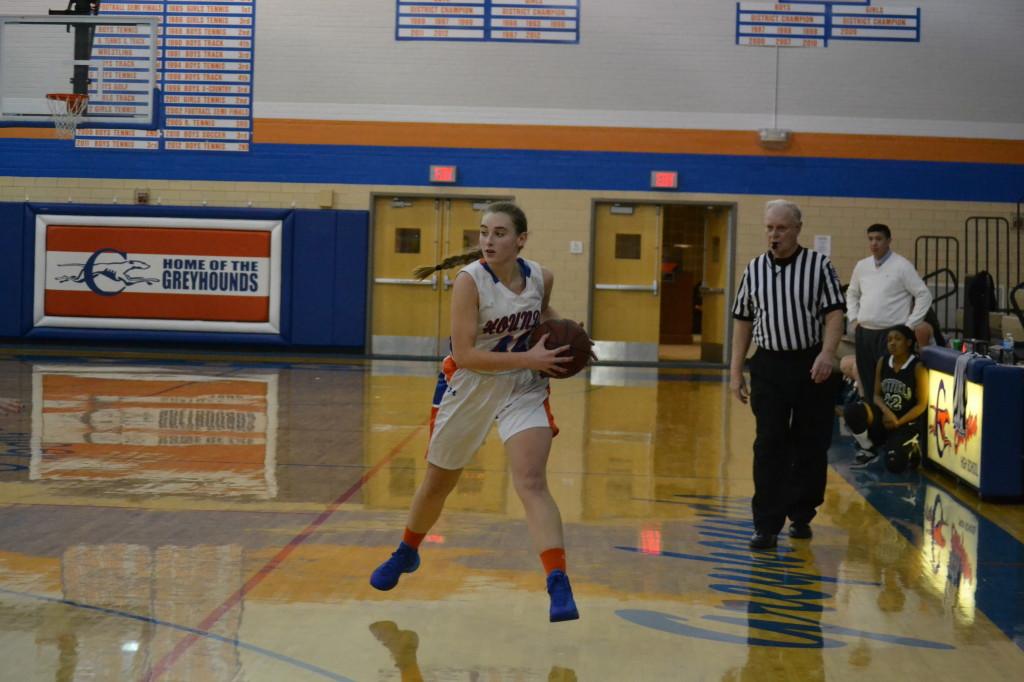 Senior Colleen Ahearn protects the ball at Stuber Gym. The girls' basketball team defeated Brentwood 54 - 25. (Ryan Fletcher)