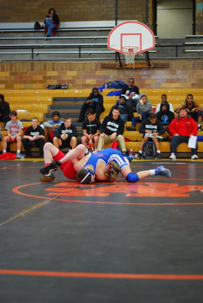 Michael Painter pins opponent from Chaminade at University City High School.  Photo by Ben Tamsky