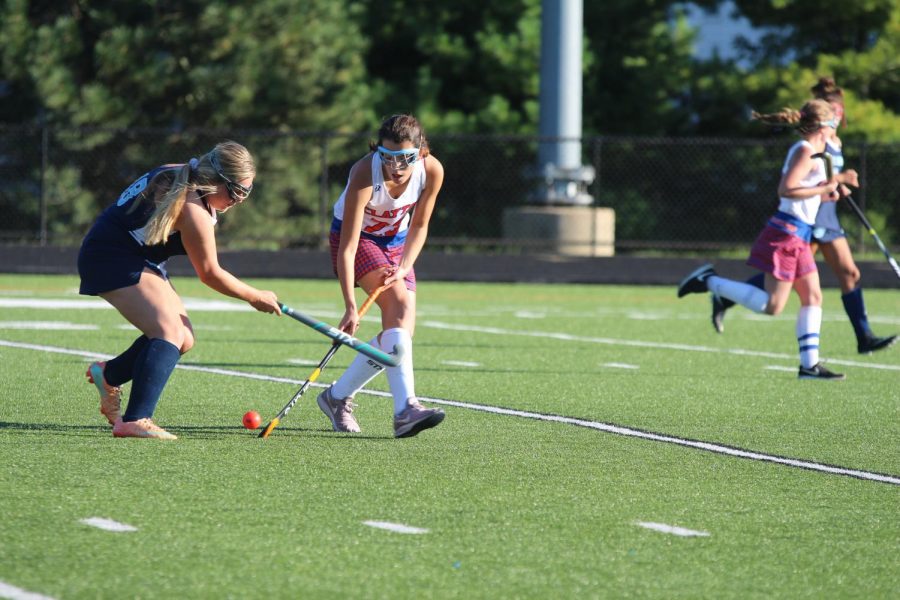 Sophomore Madalyn Schroeder (23) faces off against an opponent from Marquette Catholic during the game on Monday.