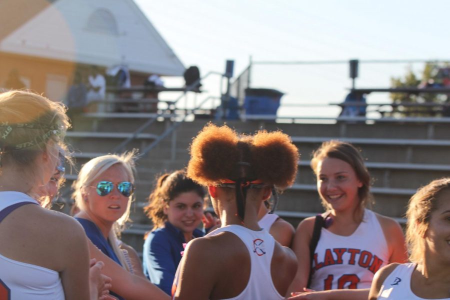 The field hockey team discusses strategy on the sidelines during their game on Monday against Marquette Catholic, which they won 3-0.