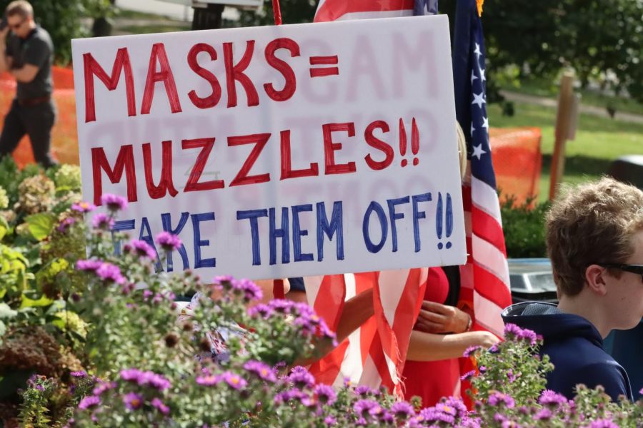 Participants at a shaw park rally held signs expressing their views, ranging from outright COVID denial to opposition to mask and vaccine mandates.