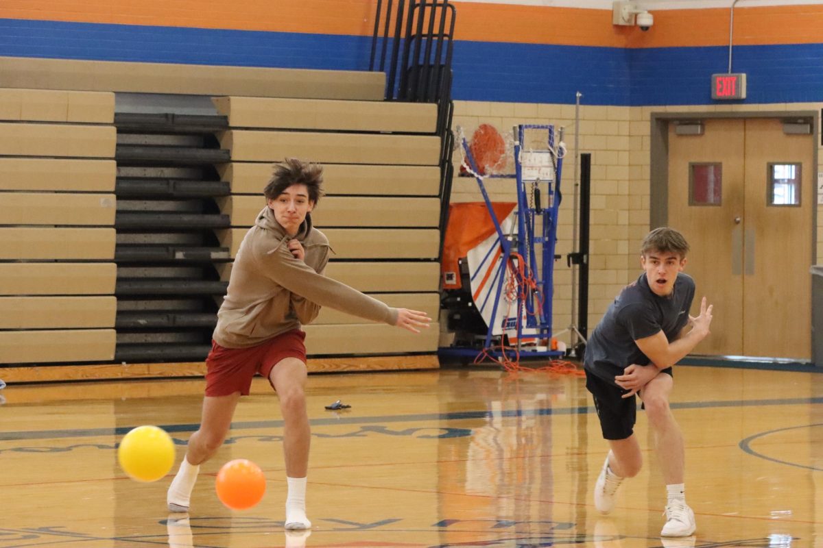 Trying to take out their opponents, juniors Liam Schafer and Tommy Leary compete in a school spirited friendly dodgeball rivalry. 