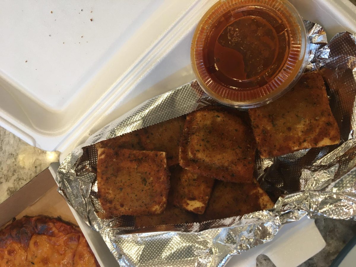 An eight piece serving of toasted ravioli with marinara on the side from IMOs.