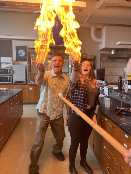 Science Department Head Nathan Peck conducts a fire bubble experiement with junior Hannah Yurkovich. This experiment explores energy, heat, pressure, states of matter, chemical reactions and water.