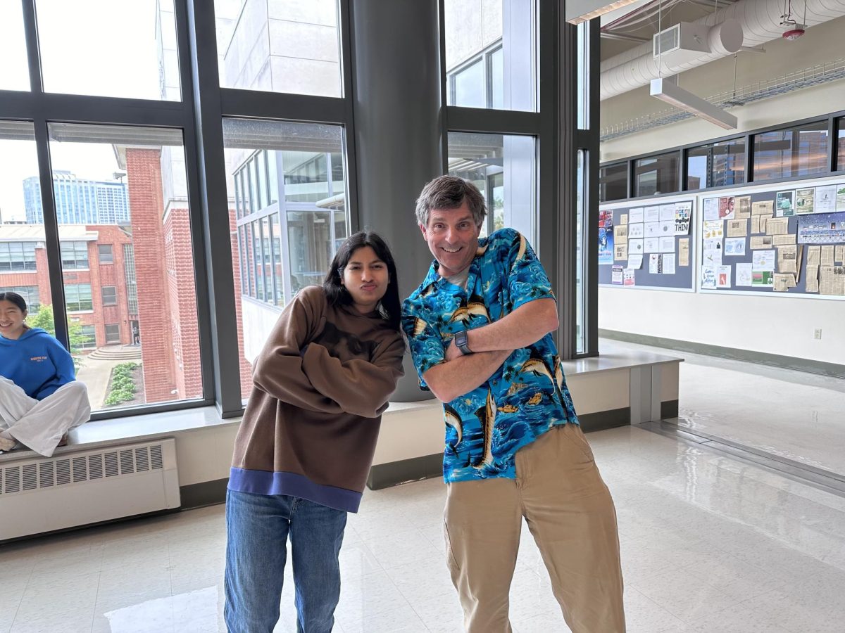 Junior Mohini Mahajan poses on a normal Monday when science teacher Nathan Peck wears his classic Hawaiian print.