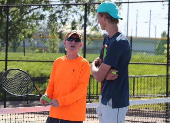 Borst talks to junior Joe Major during practice about strategies for their upcoming match.