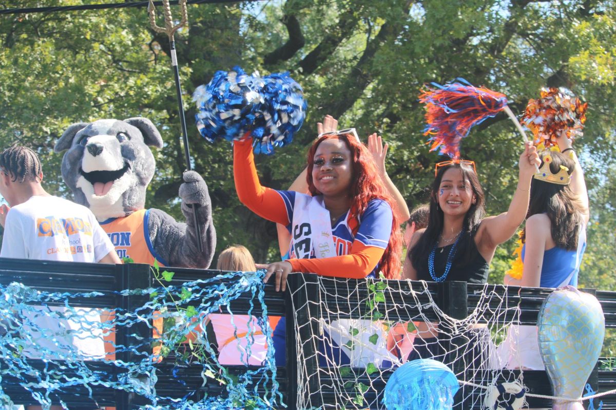 Seniors Jadah Tabb and Mazlin McGrath wave from the senior class float decorated for the Greek God Poseidon. At the homecoming football game, it was announced that the senior class won the Golden Greyhound as the most spirited class. “I enjoyed being on the senior float because everyone was so spirited and dressed up for the occasion,” senior Alyssa Blanke said. “We did the float on one of my dad’s delivery trucks, so it was a huge float with so many decorations. My dad drove the float too, so it was amazing father-daughter bonding time.”