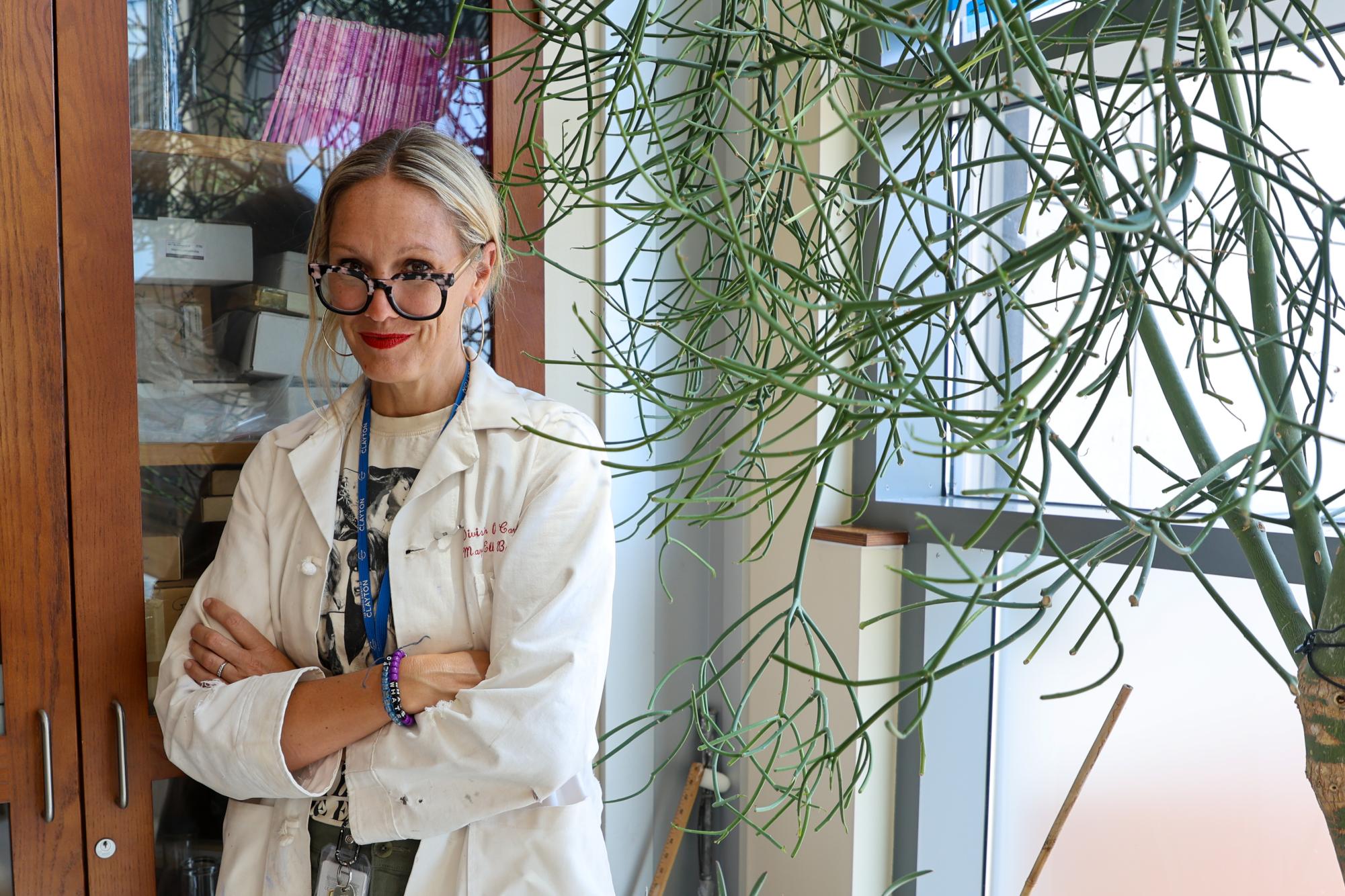 AP Chemistry teacher Mary Russo poses in her new classroom. “A lot of my teachers were male when I got to my upper level chemistry. There's nothing wrong with that, but maybe I can show folks that anyone can do science at a very high level,” Russo said.