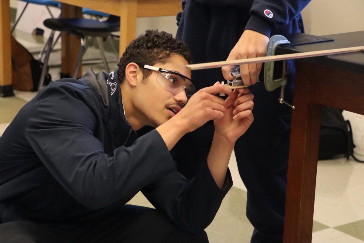 On Thursday, Oct. 24, first-period AP Physics I and II senior Logan Huyette participates in a momentum lab in which they shot one ball into another. "Physics has always been the subject with the most boring laboratory experiments. In Chemistry, we get to blow things up, in Biology, we get to annoy Mr Bergeron, yet in Physics all we do is hit stuff together to confirm relationships we already know,” Huyette said. “Yet AP Physics this year has been an absolute blast, because it's not the labs that make the class, it is the people. I'm surrounded by the amazing classmates—in character and intelligence—that AP physics is filled with this year."