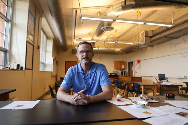 Physics teacher Greg Schade poses in his new classroom. "Clayton has quite the reputation of being a really good school, so that excited me," Schade said. "And then Clayton High School does Physics first, which is not that common, but I love it."