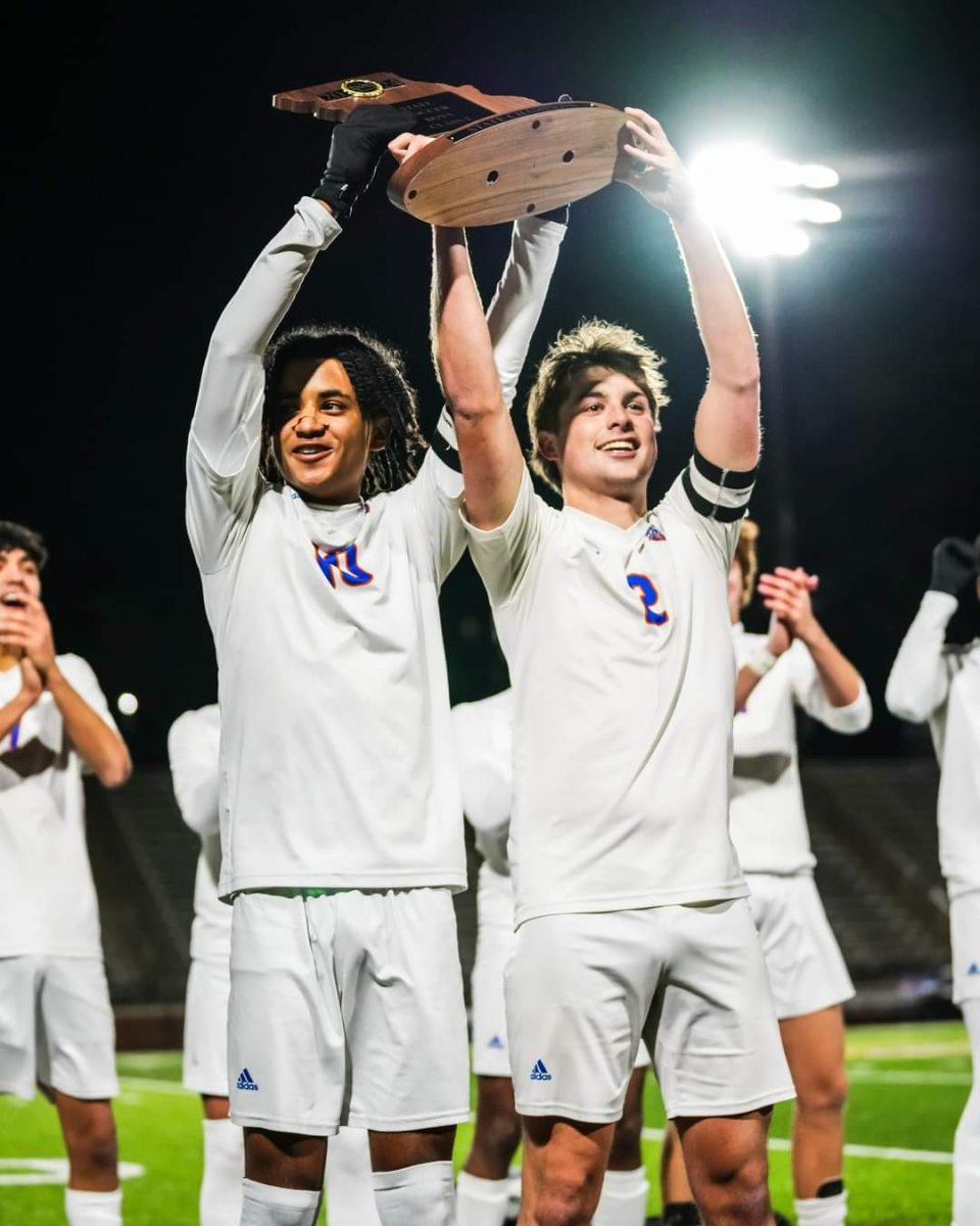 Seniors Wole Adeoye and Elias Kilbridge celebrate after winning the Class 2 state soccer championships. The varsity team defeated St. Michael the Archangel 3-0.