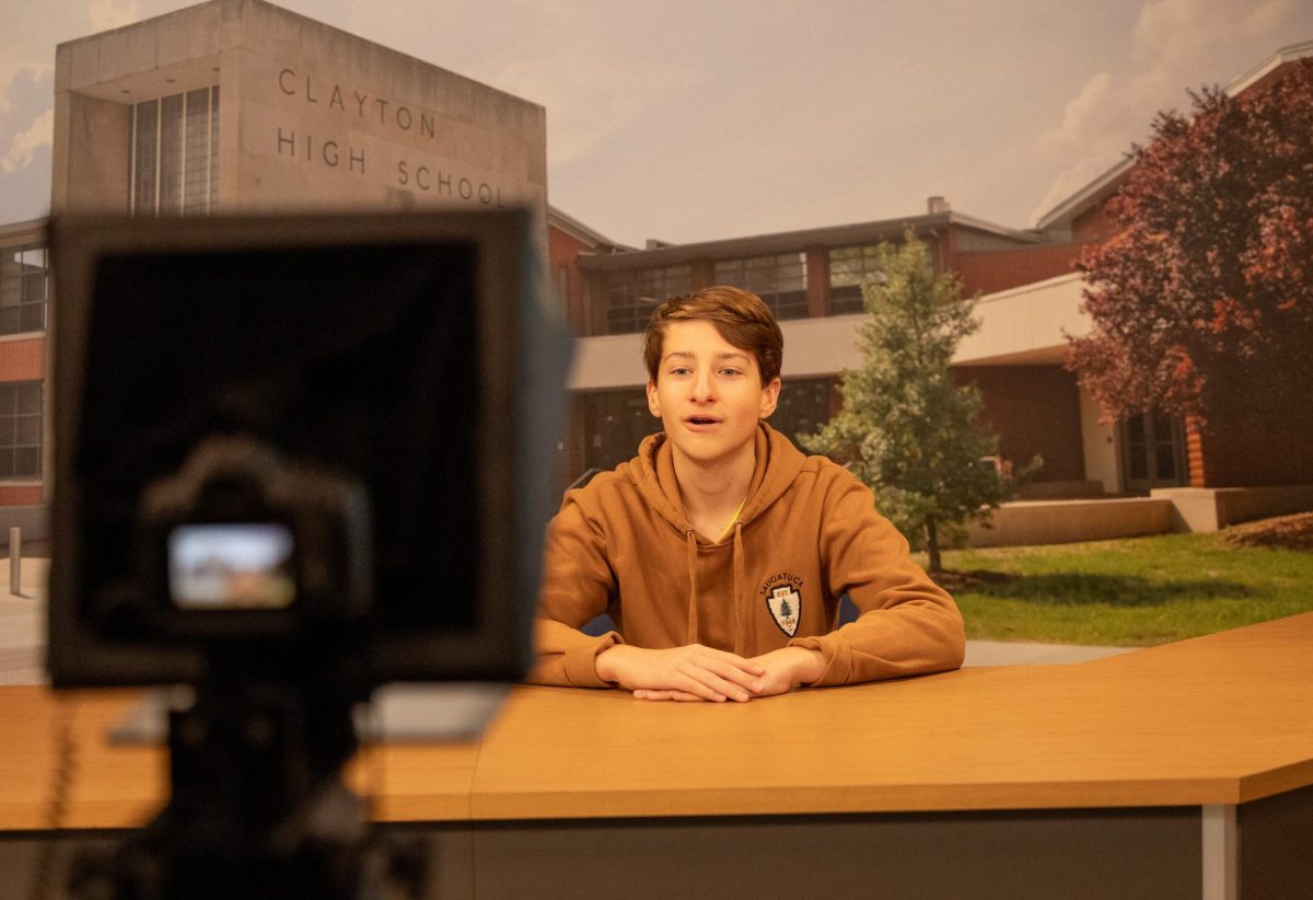 Sophomore Brady Fogle films the daily video announcements in video production class.