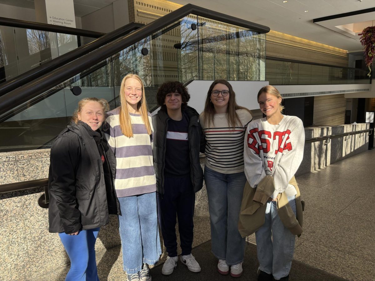 Seniors Grace Kalina, Analee Miller, Yehia Said, Anais Oge and Harper Mettes stand in the entrance of the St. Louis Art Museum while on the field trip for French Cinema and Conversation.