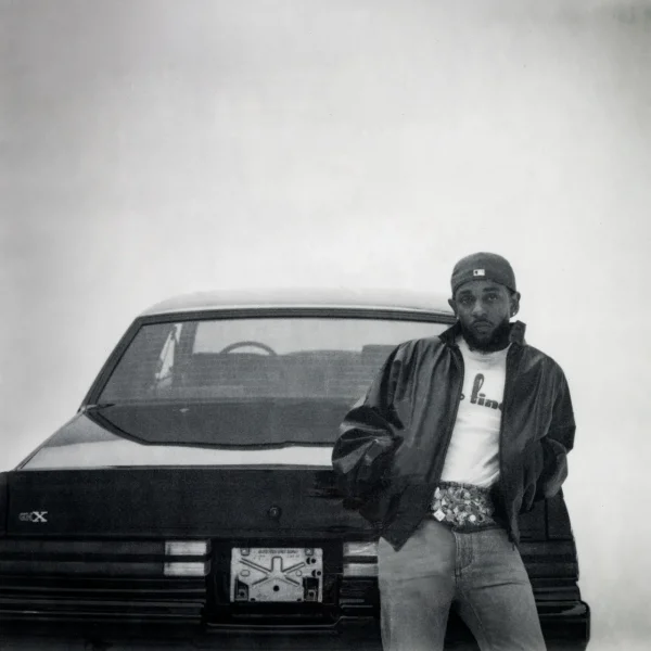 A black-and-white vignetted photo of Lamar leaning against the back of the titular GNX. Photo taken by pgLang under exclusive license to Interscope Records.