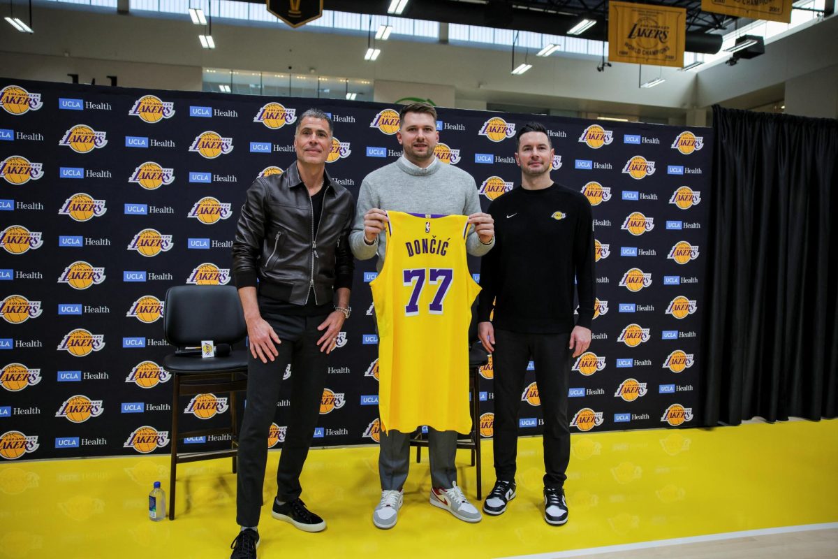 Rob Pelinka, GM of Los Angeles Lakers, Luka Doncic and Lakers' head coach JJ Reddick pose for a picture as Doncic holds his jersey on the day of his first press conference after being traded from Dallas Mavericks to Los Angeles Lakers, at the UCLA Health Training Center, in El Segundo, California, U.S., Feb. 4, 2025. 