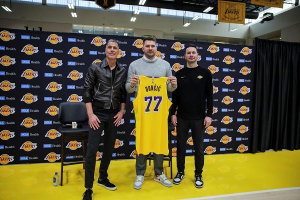 Rob Pelinka, GM of Los Angeles Lakers, Luka Doncic and Lakers' head coach JJ Reddick pose for a picture as Doncic holds his jersey on the day of his first press conference after being traded from Dallas Mavericks to Los Angeles Lakers, at the UCLA Health Training Center, in El Segundo, California, U.S., Feb. 4, 2025. 