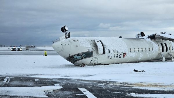 The wreckage of a Delta Air Lines operated CRJ-900 aircraft lies crashed on the runway at Toronto Pearson International Airport in Mississauga, Ontario, Canada February 18, 2025.   TSB/Handout via REUTERS