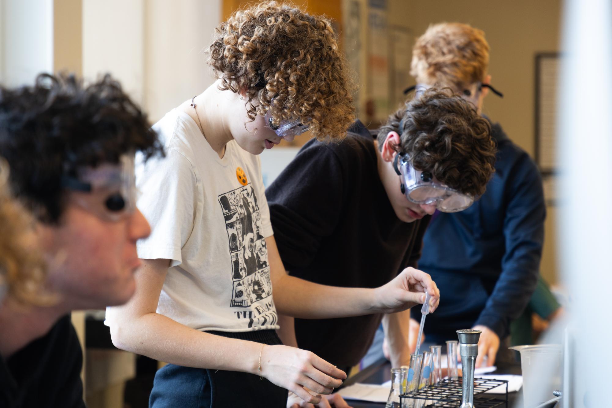 During AP Honors Chemistry, sophomores Dwight Erdmann and Aud Shulz use pipettes in a reactions lab. Verby’s class, part of the STEM curriculum, focused on developing skills such as data analysis, Claim-Evidence-Reasoning (CER) writing and organizational techniques, preparing students for future academic and professional responsibilities.