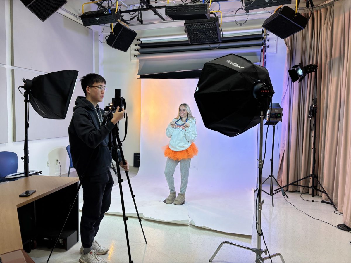 Senior Riley Zimmerman poses for senior superlative photos before school on Monday, Feb. 24.